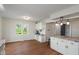 Kitchen area featuring wood flooring, white cabinetry, and a convenient coffee station with natural light at 1285 S 1100 E, Zionsville, IN 46077