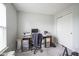 Neutral bedroom featuring gray walls, carpet, closet and a functional desk area at 13451 All American Rd, Fishers, IN 46037