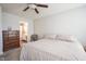 Cozy bedroom featuring a ceiling fan, neutral walls, and a convenient en-suite bathroom at 13451 All American Rd, Fishers, IN 46037