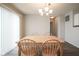 Bright dining space with wooden table, chandelier, and access to the kitchen at 13451 All American Rd, Fishers, IN 46037