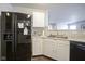 Kitchen with black refrigerator and modern stainless steel sink plus white cabinets at 13451 All American Rd, Fishers, IN 46037