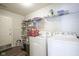 Laundry room with ample storage, shelving, and modern washer and dryer units at 13451 All American Rd, Fishers, IN 46037