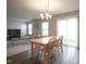 Bright living room and dining area features wood floors, neutral paint, and natural light from large windows at 13451 All American Rd, Fishers, IN 46037