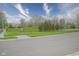 Scenic view of a tranquil pond surrounded by lush landscaping in a serene neighborhood setting at 13451 All American Rd, Fishers, IN 46037