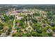 Wide aerial view of the neighborhood showcasing homes and nearby school, sport fields, and water tower at 150 Church St, Mooresville, IN 46158