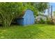 Backyard with a blue storage shed surrounded by mature trees at 150 Church St, Mooresville, IN 46158