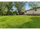 Spacious backyard featuring a swing set, dog kennel, mature trees, and well-kept lawn at 150 Church St, Mooresville, IN 46158