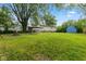 Large backyard featuring well-maintained lawn, storage shed, and mature trees at 150 Church St, Mooresville, IN 46158