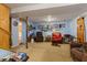 Finished basement with comfortable seating, wall decor, and access to stairs and another room at 150 Church St, Mooresville, IN 46158