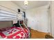 Bedroom featuring a bunk bed with a red and white quilt, chest, and doorway at 150 Church St, Mooresville, IN 46158