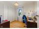 Bright bedroom featuring light hardwood floors, large closet, and a dedicated desk space at 150 Church St, Mooresville, IN 46158