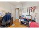 Bedroom with a desk and chair, a storage shelf, and a doorway at 150 Church St, Mooresville, IN 46158