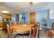 Dining area with round table, wooden chairs, and view of the kitchen area at 150 Church St, Mooresville, IN 46158