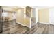 Open basement area with wood floors, stairs to the upper level, and neutral paint at 1509 S Spencer Ave, Indianapolis, IN 46203