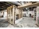Unfinished basement framed with stairs, showing exposed pipes and unfinished flooring at 1509 S Spencer Ave, Indianapolis, IN 46203