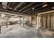 Unfinished basement framed with stairs, showing exposed pipes and unfinished flooring at 1509 S Spencer Ave, Indianapolis, IN 46203