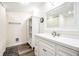 Bright bathroom features a white vanity, a large mirror, and hardwood floors at 1509 S Spencer Ave, Indianapolis, IN 46203