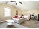 Large bedroom with seating area, ceiling fan, and lots of natural light at 1509 S Spencer Ave, Indianapolis, IN 46203