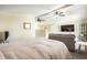 Spacious bedroom features a bed, seating area, and ceiling fans at 1509 S Spencer Ave, Indianapolis, IN 46203