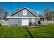 Exterior view showcases a modern gray home and a covered patio in the backyard at 1509 S Spencer Ave, Indianapolis, IN 46203