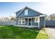 Inviting curb appeal with a well-manicured lawn and covered porch at 1509 S Spencer Ave, Indianapolis, IN 46203