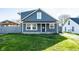 Charming home featuring a cozy front porch and well-maintained lawn at 1509 S Spencer Ave, Indianapolis, IN 46203