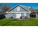 Exterior view showcases a modern gray home and a covered patio in the backyard at 1509 S Spencer Ave, Indianapolis, IN 46203