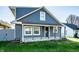 View of an attractive two-story home with a quaint covered front porch at 1509 S Spencer Ave, Indianapolis, IN 46203
