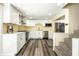 Bright kitchen with stainless steel appliances, white cabinetry, and wood flooring at 1509 S Spencer Ave, Indianapolis, IN 46203