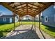 View of a covered patio with a gravel floor and an exposed wooden roof at 1509 S Spencer Ave, Indianapolis, IN 46203