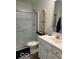 Well-lit bathroom featuring a shower, toilet, vanity with sink, and decorative accents at 1511 Coen Ct, Columbus, IN 47201