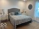 Comfortable bedroom featuring a large bed with floral bedding and matching bedside tables at 1511 Coen Ct, Columbus, IN 47201