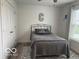 Small bedroom with neutral color palette featuring natural light and a clothing closet at 1511 Coen Ct, Columbus, IN 47201