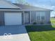 Charming single story home with gray siding, brick accents, and a well-maintained lawn at 1511 Coen Ct, Columbus, IN 47201
