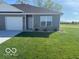 Inviting single-story home with a manicured lawn and blue sky at 1511 Coen Ct, Columbus, IN 47201