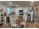 Eat-in kitchen featuring stainless steel appliances, white cabinets, and wood-look flooring at 1511 Coen Ct, Columbus, IN 47201