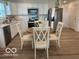 Eat-in kitchen featuring stainless steel appliances, white cabinets, and wood-look flooring at 1511 Coen Ct, Columbus, IN 47201