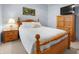 Comfortable bedroom with queen size bed, white comforter, floral pillows, bedside table and TV on dresser at 16201 Haywood St, Fishers, IN 46037