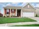 Charming single-Gathering home boasts a manicured lawn, brick facade, and inviting front porch at 16201 Haywood St, Fishers, IN 46037