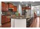 Kitchen with granite countertops, cherry cabinets, stainless steel appliances, and breakfast bar seating at 16201 Haywood St, Fishers, IN 46037