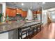 Kitchen with granite countertops, cherry cabinets, stainless steel appliances, and breakfast bar seating at 16201 Haywood St, Fishers, IN 46037