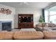 Comfortable living room featuring a fireplace, built-in shelving, and plush seating at 16201 Haywood St, Fishers, IN 46037