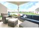 Relaxing covered patio with comfortable seating overlooking a serene pond and lush greenery at 16201 Haywood St, Fishers, IN 46037