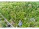An aerial view of the property, which is surrounded by green trees and a long dirt driveway at 1630 Hinson Rd, Martinsville, IN 46151