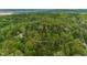 Lush green forest landscape with cabins, nearby buildings, and roads, captured from above at 1630 Hinson Rd, Martinsville, IN 46151