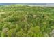 An aerial shot showcasing the surrounding forest with the house nestled in the trees at 1630 Hinson Rd, Martinsville, IN 46151