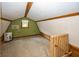 Finished attic with carpet, exposed beams, a wall AC unit, and a window at 1630 Hinson Rd, Martinsville, IN 46151