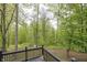 Enjoy the serene wooded backyard view from the black wood porch, offering privacy and nature at 1630 Hinson Rd, Martinsville, IN 46151