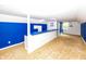 Unfinished basement with bar, bright blue accents, and natural light from a window at 1630 Hinson Rd, Martinsville, IN 46151