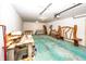 Unfinished basement with painted floor, work table and various furniture pieces at 1630 Hinson Rd, Martinsville, IN 46151